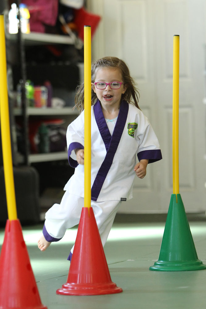 FUNdamental Movement Skills in action - Girl running in between cones showing agility