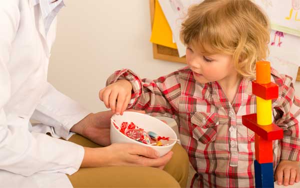 Child receiving a sweet reward (could easily be stickers too)