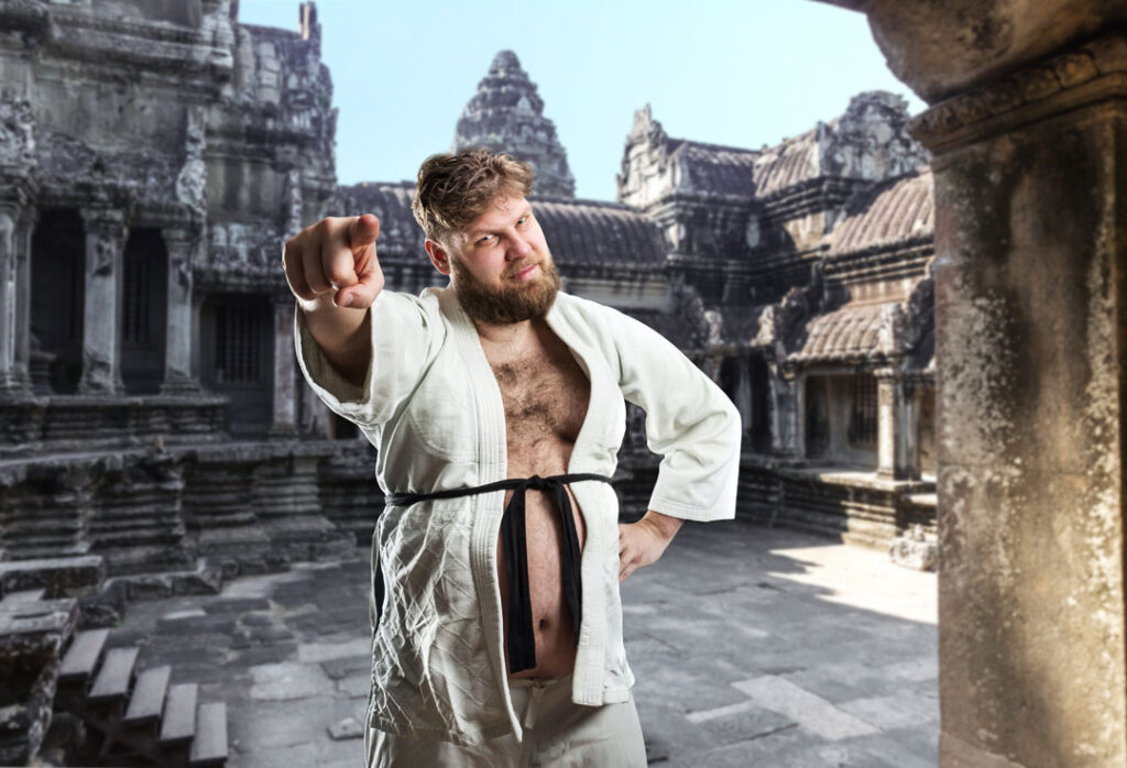 Do as i say, not as i do. Over weight man in karate uniform with black belt