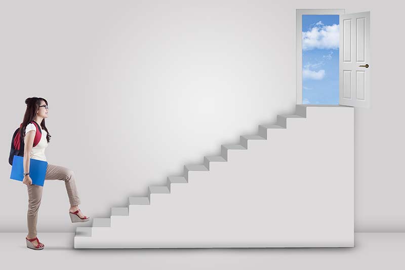 Teen walking up stairs to success